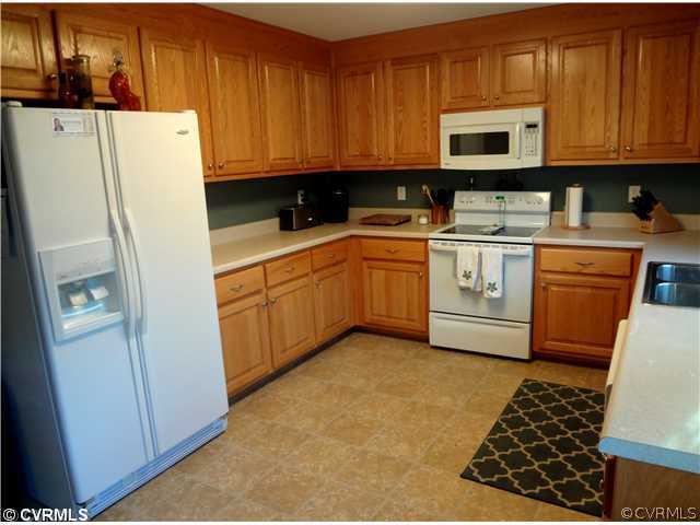 20310 Halligan Park Road Carson, VA 23830 - Photo 13 of 24 a kitchen with stainless steel appliances granite countertop a refrigerator sink and cabinets
