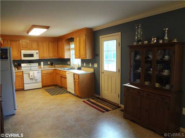 20310 Halligan Park Road Carson, VA 23830 - Photo 14 of 24 a kitchen with stainless steel appliances granite countertop a refrigerator a sink dishwasher a stove with wooden cabinets and floor