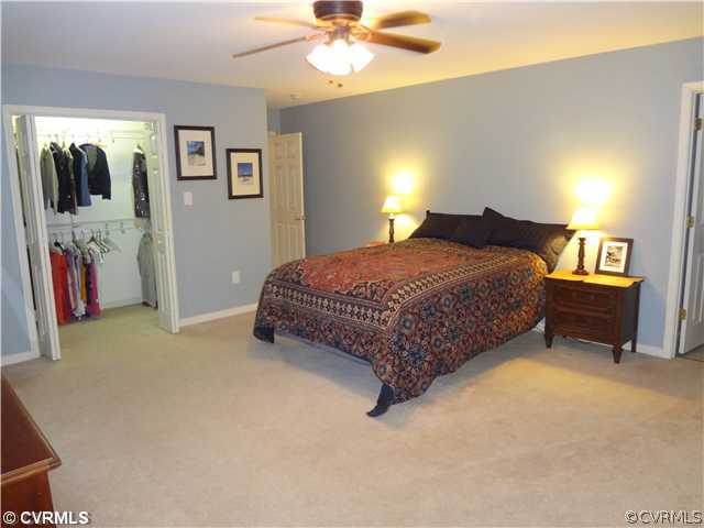 20310 Halligan Park Road Carson, VA 23830 - Photo 15 of 24 a bedroom with a bed and a chandelier