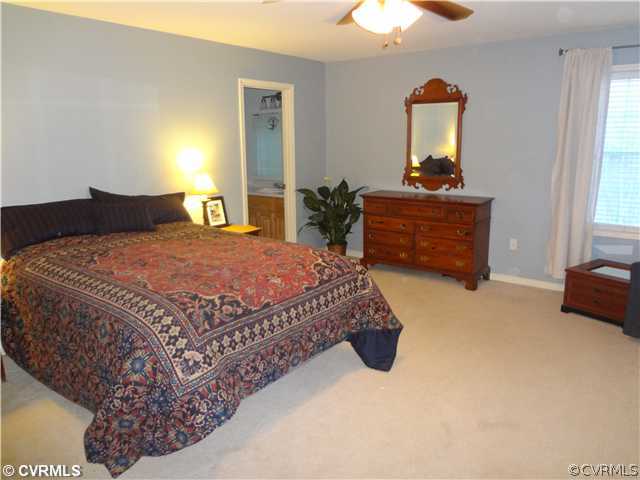 20310 Halligan Park Road Carson, VA 23830 - Photo 16 of 24 a bedroom with a bed and a chandelier