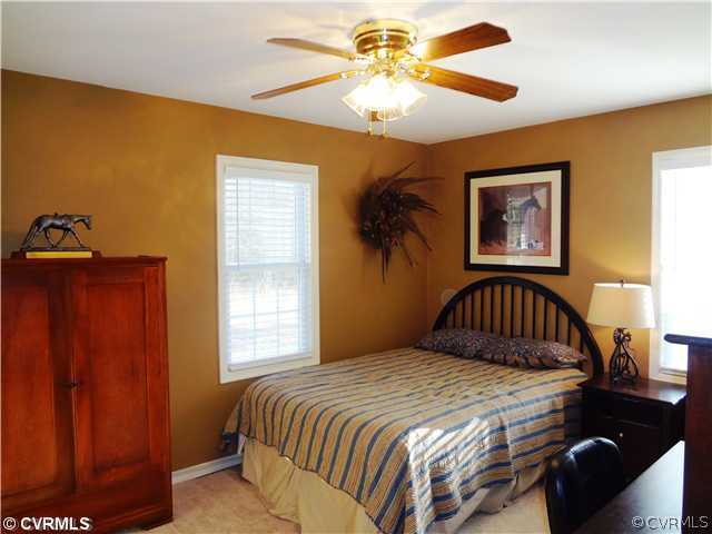 20310 Halligan Park Road Carson, VA 23830 - Photo 19 of 24 a bedroom with a bed and a chandelier