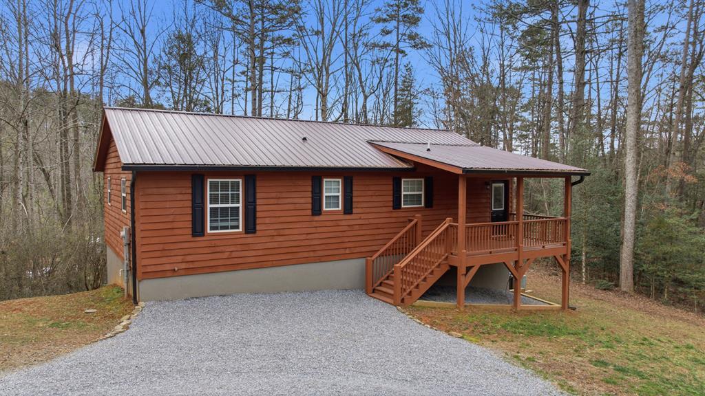 a view of a house with a patio and a yard