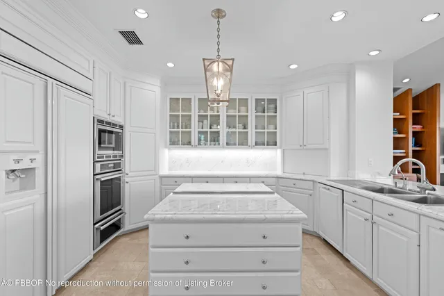 a utility room with a sink and cabinets