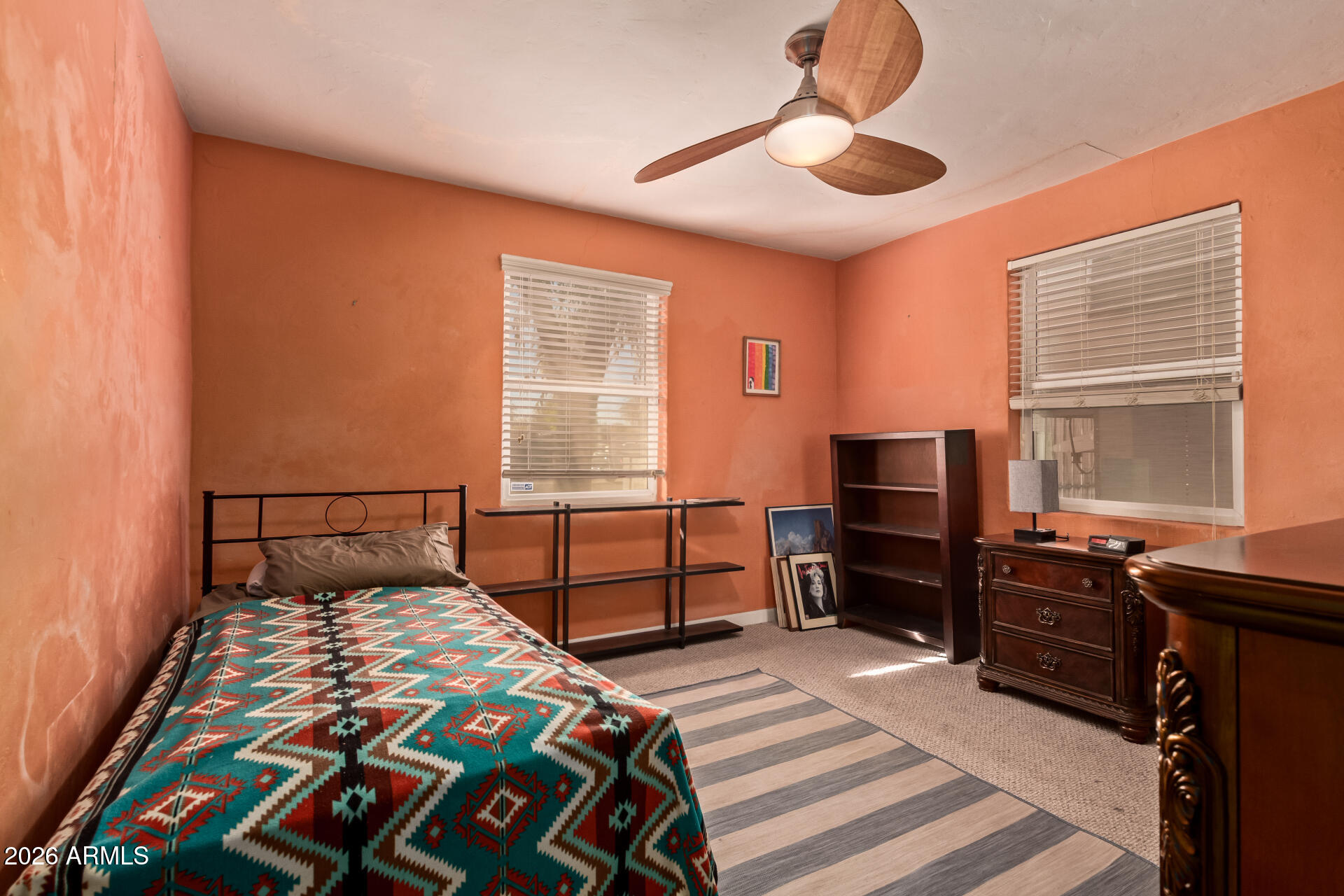 4413 North 19th Place Phoenix, AZ 85016 - Photo 10 of 14 a bedroom with a bed and a chandelier