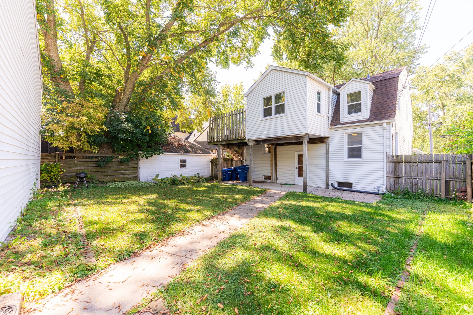 512 North 6th Street, Unit 2 DeKalb, IL 60115 - Photo 16 of 16 a view of a house with a yard and large tree