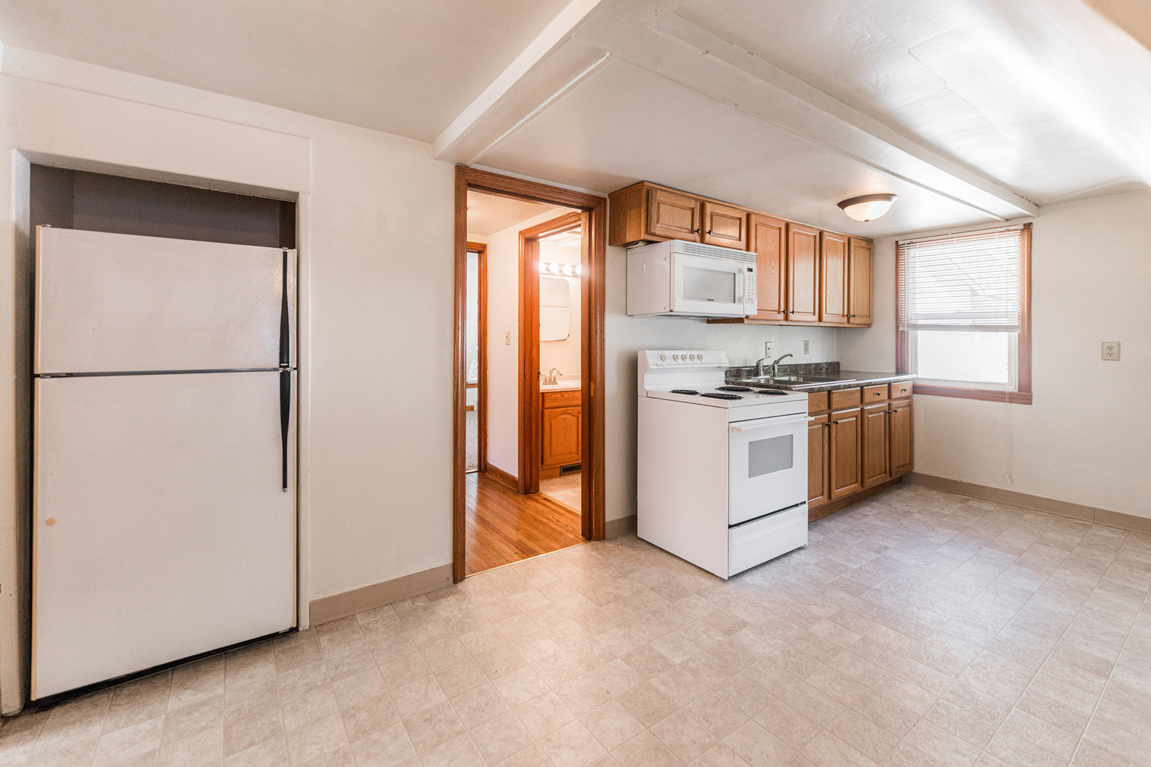 512 North 6th Street, Unit 2 DeKalb, IL 60115 - Photo 6 of 16 a kitchen with stainless steel appliances granite countertop a refrigerator a sink a stove and white cabinets