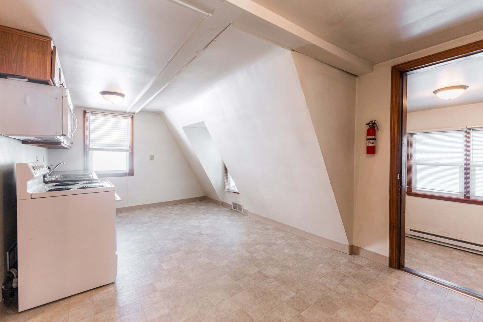 512 North 6th Street, Unit 2 DeKalb, IL 60115 - Photo 7 of 16 a view of a kitchen with fridge and wooden floor