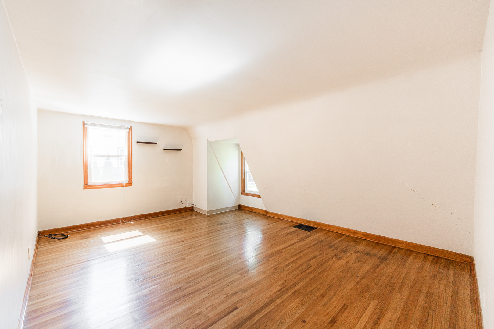 512 North 6th Street, Unit 2 DeKalb, IL 60115 - Photo 9 of 16 an empty room with wooden floor and windows