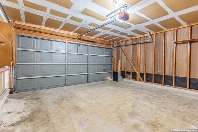 a view of an empty room with a ceiling fan