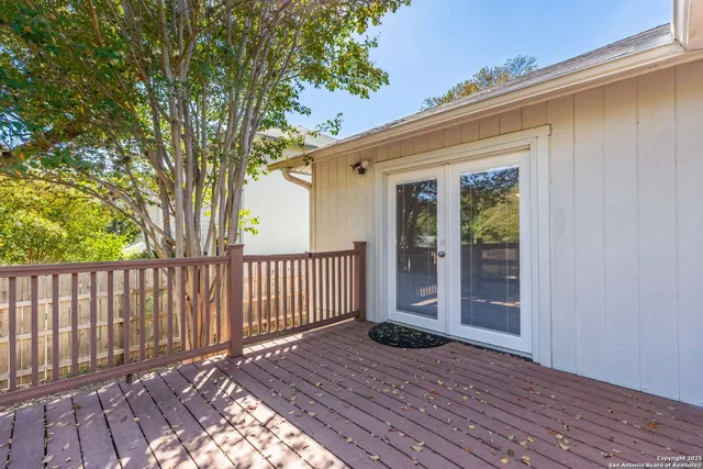 a view of backyard with deck and wooden floor