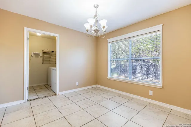 a view of an empty room with a window