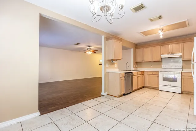 a kitchen with a stove a sink and a refrigerator