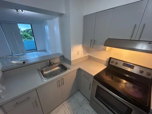 a stove top oven sitting inside of a kitchen