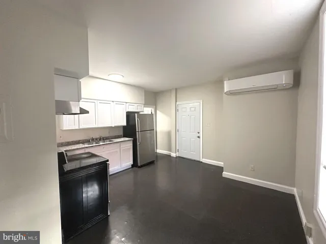 a kitchen with cabinets stainless steel appliances and wooden floor