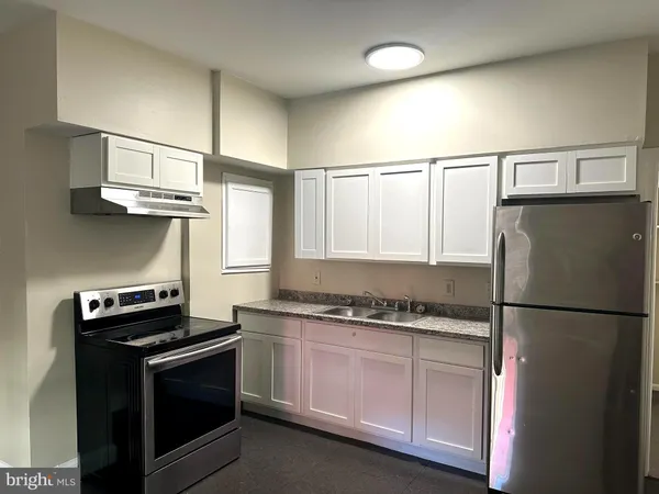 a kitchen with stainless steel appliances a stove and a refrigerator