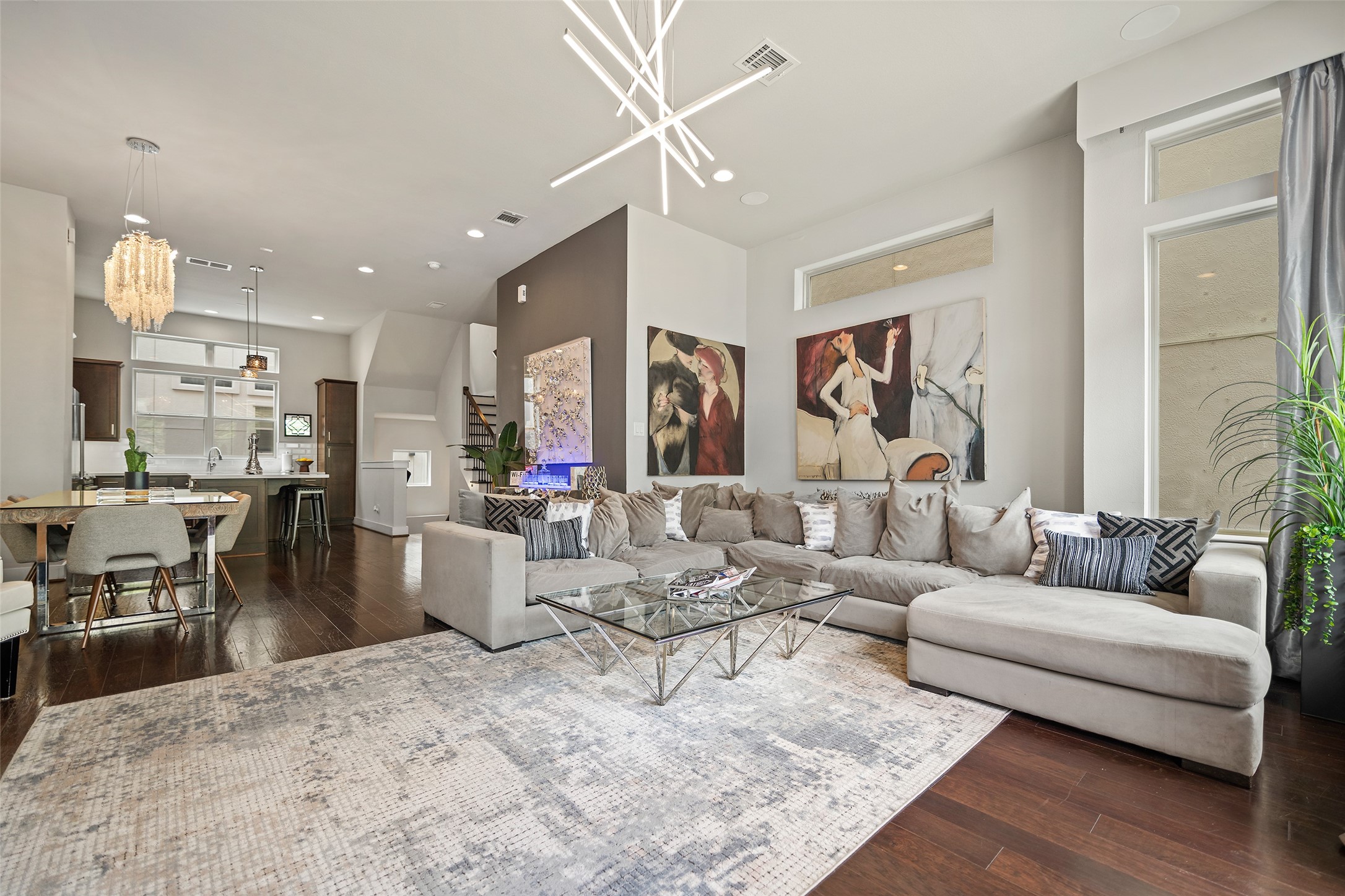 4413 Eli Street Houston, TX 77007 - Photo 1 of 47 a living room with furniture kitchen view and a chandelier