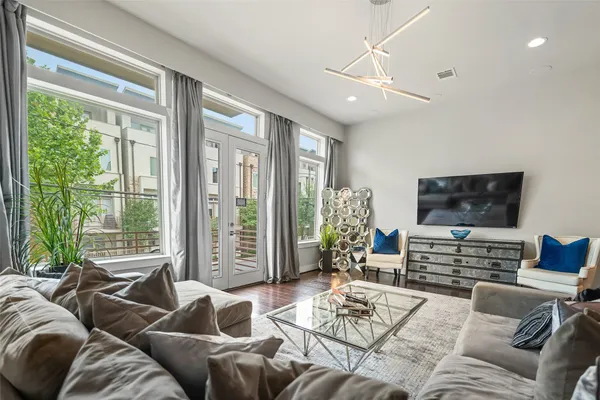 a spacious bedroom with a bed and a chandelier