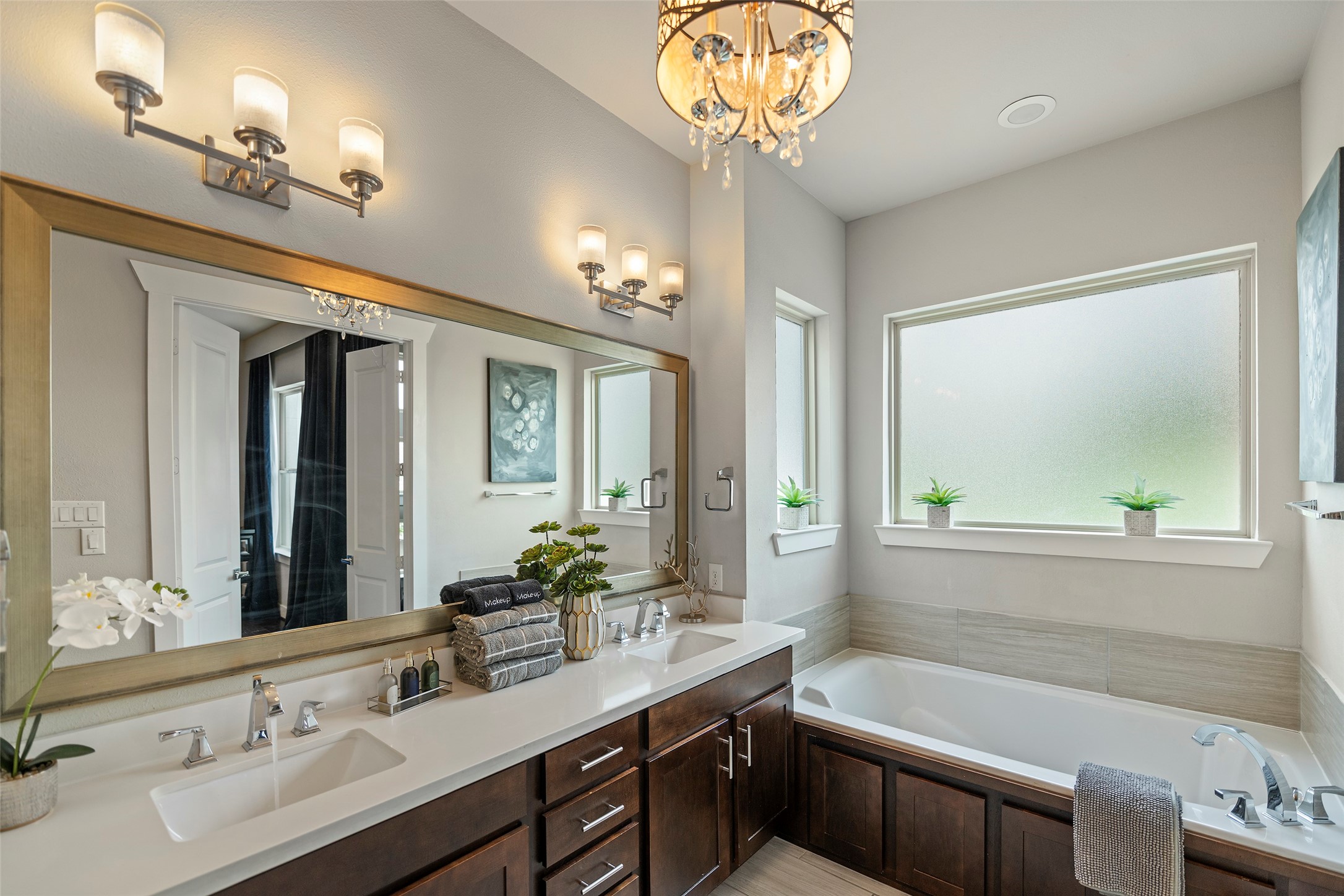 4413 Eli Street Houston, TX 77007 - Photo 28 of 47 a bathroom with a sink a large mirror and a bathtub with a potted plant