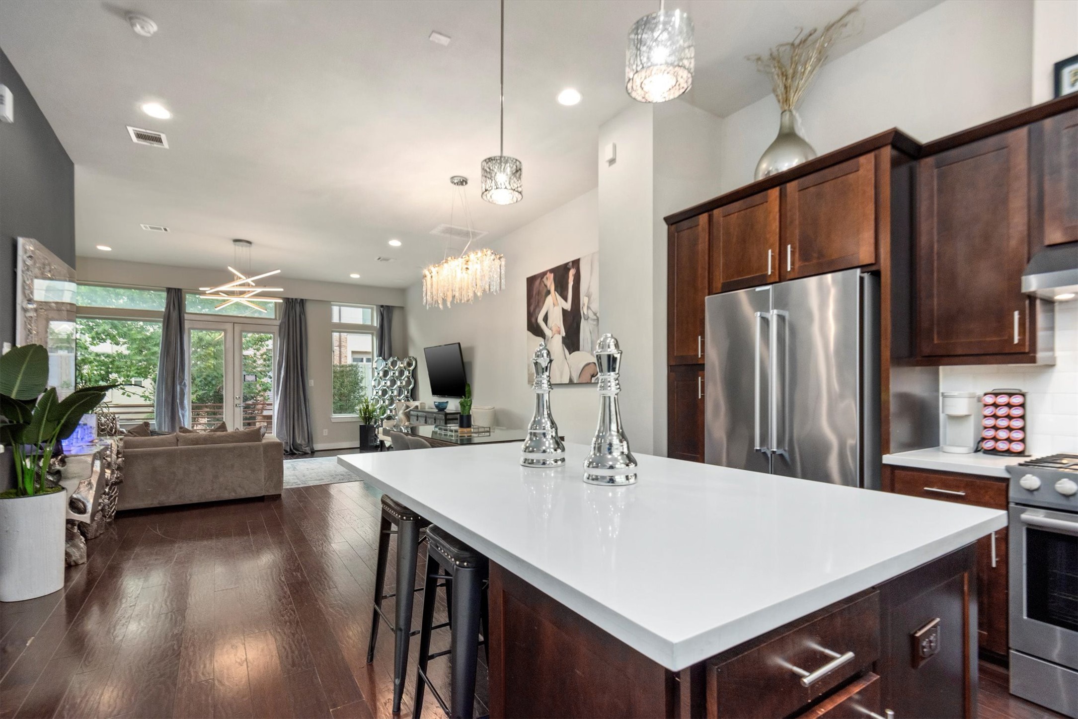 4413 Eli Street Houston, TX 77007 - Photo 4 of 47 a kitchen with stainless steel appliances a dining table chairs stove and refrigerator