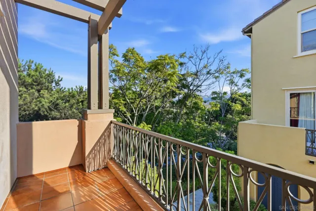 a view of a balcony with flower plants