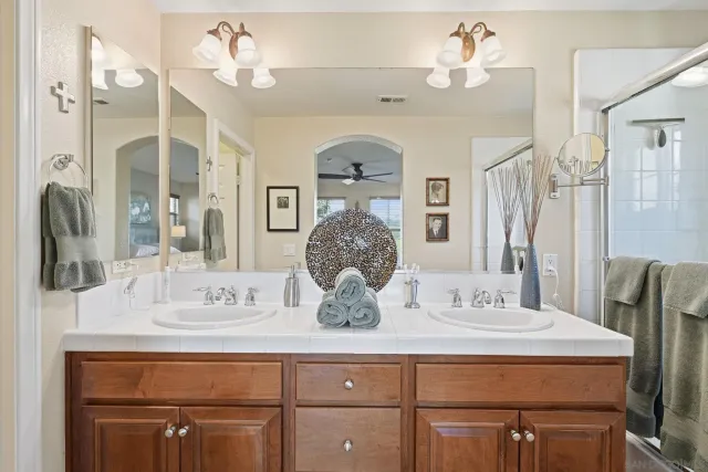 a bathroom with a double vanity sink and a mirror