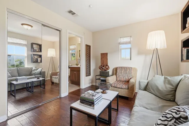 a living room with furniture and wooden floor