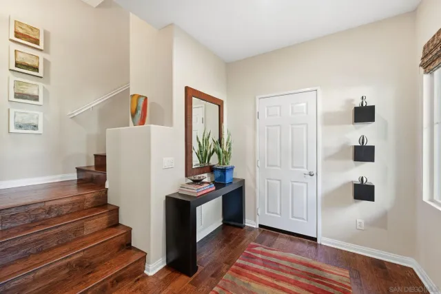 a view of a hallway with closet and wooden floor
