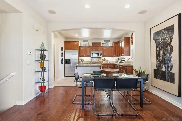 a dining room with furniture and wooden floor