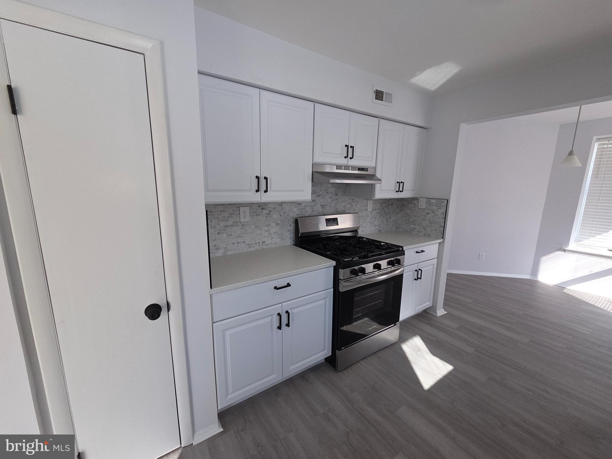 70 Suburban Boulevard Delran, NJ 08075 - Photo 8 of 40 a kitchen with stainless steel appliances a stove refrigerator and white cabinets