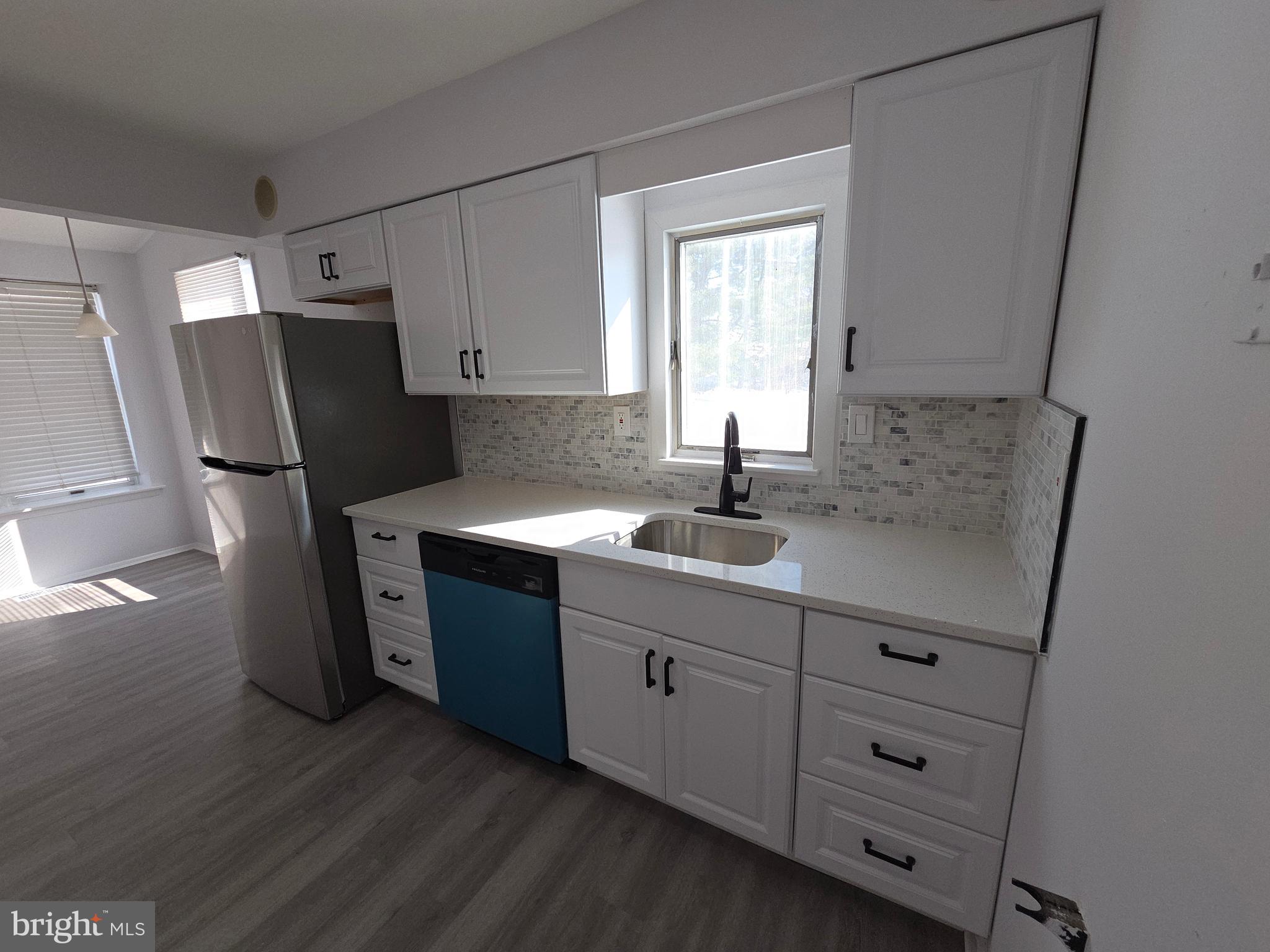 70 Suburban Boulevard Delran, NJ 08075 - Photo 9 of 40 a kitchen with sink cabinets and window