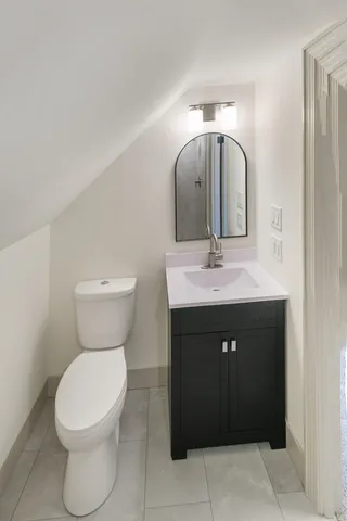 a bathroom with a sink vanity and toilet