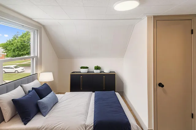 a bedroom with a bed and a window