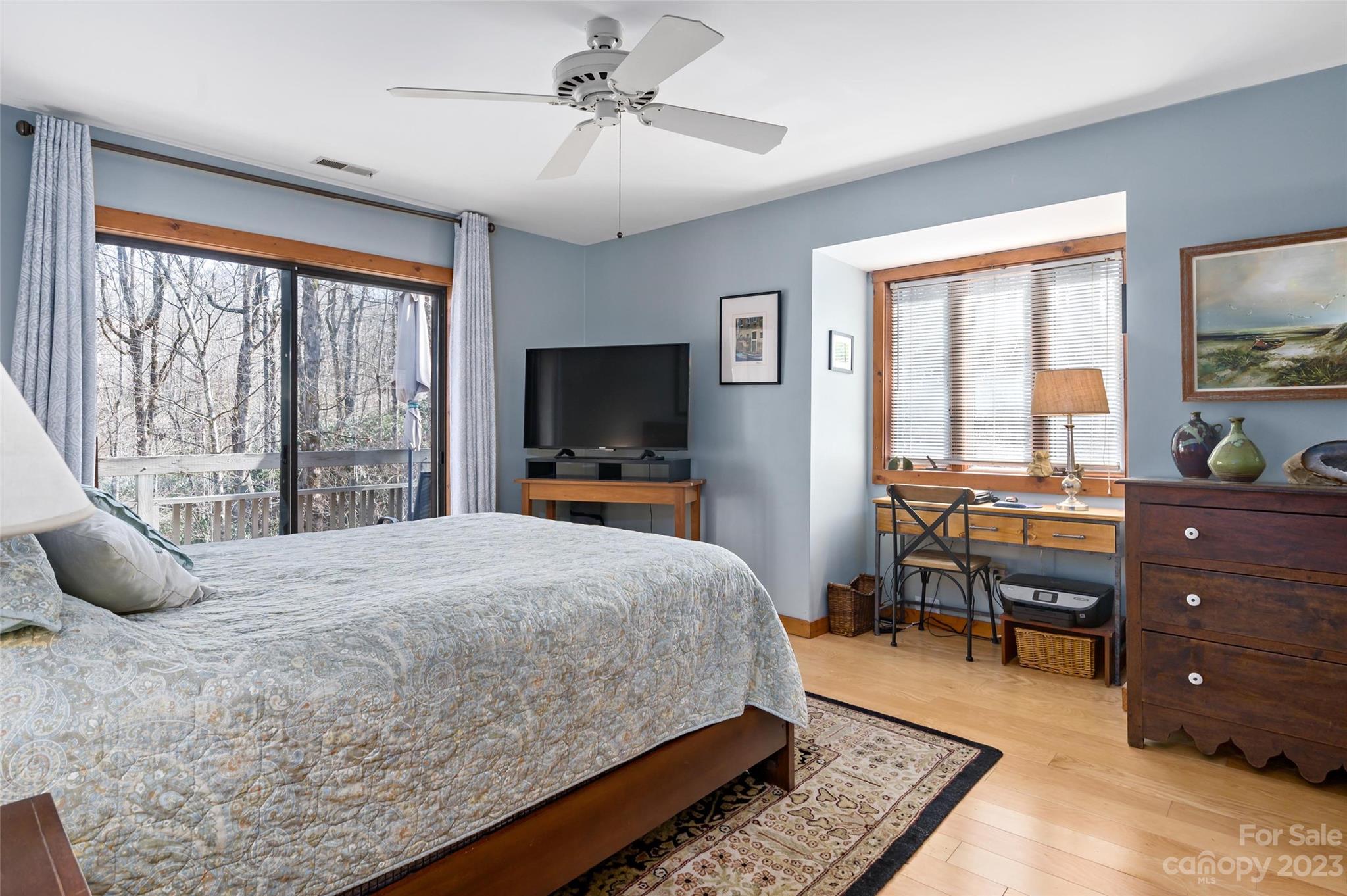 139 Panther Gap Road Brevard, NC 28712 - Photo 11 of 42 a bedroom with a bed and a flat tv screen on dresser