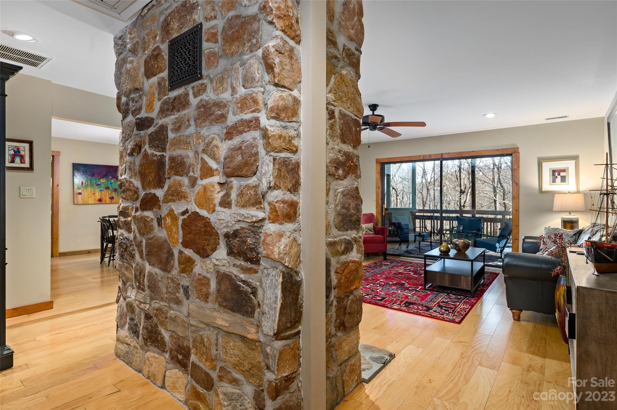 139 Panther Gap Road Brevard, NC 28712 - Photo 14 of 42 a living room with furniture and a floor to ceiling window