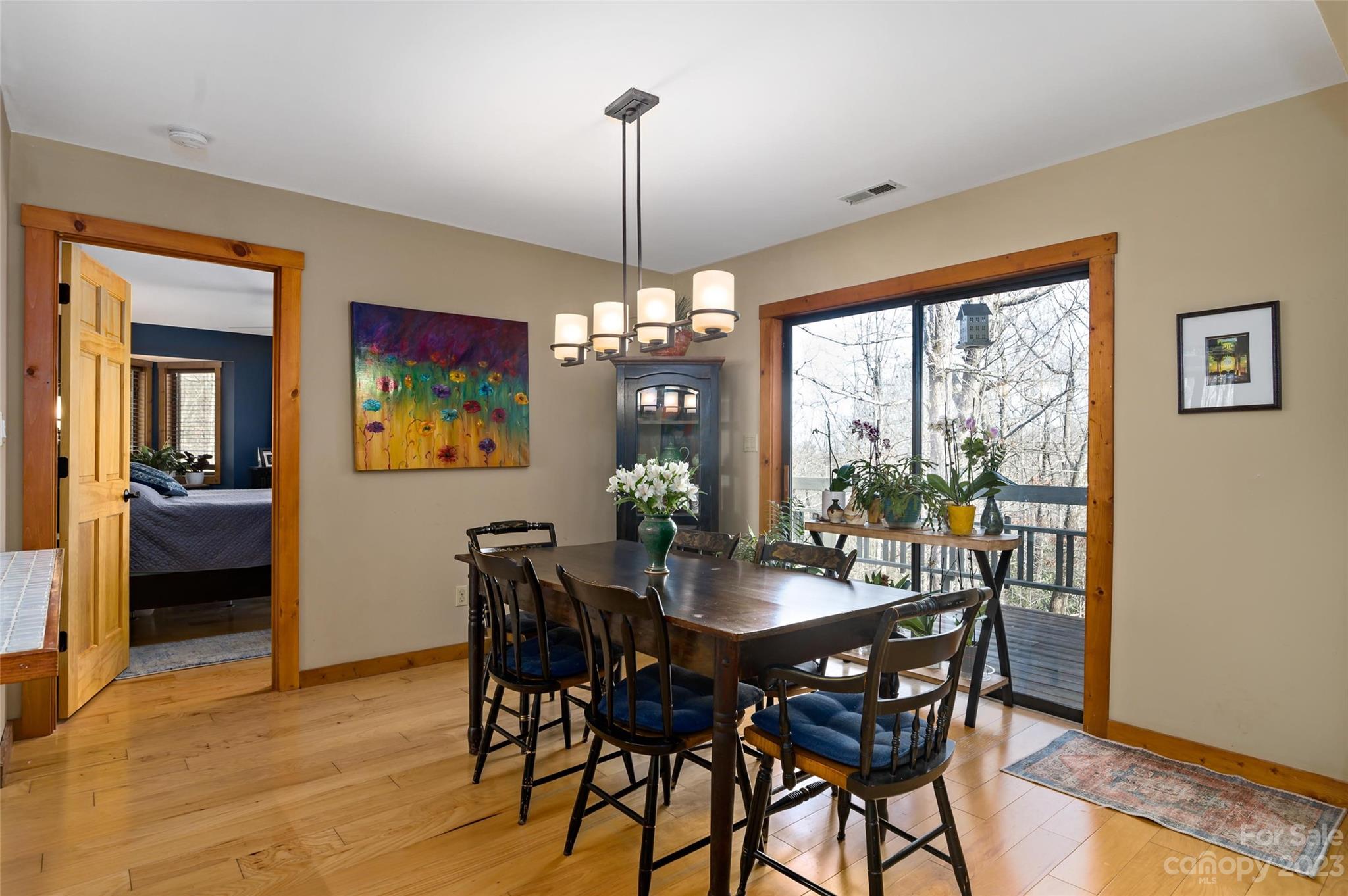 139 Panther Gap Road Brevard, NC 28712 - Photo 17 of 42 a view of a dining room with furniture window and wooden floor