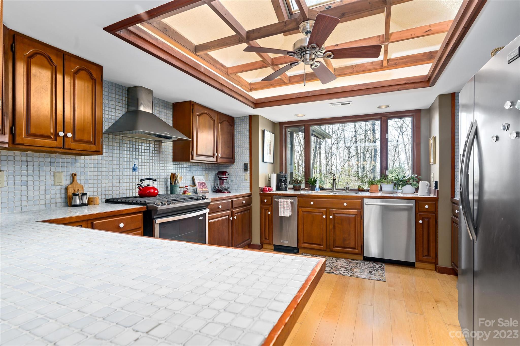 139 Panther Gap Road Brevard, NC 28712 - Photo 18 of 42 a kitchen with stainless steel appliances granite countertop a sink stove and refrigerator
