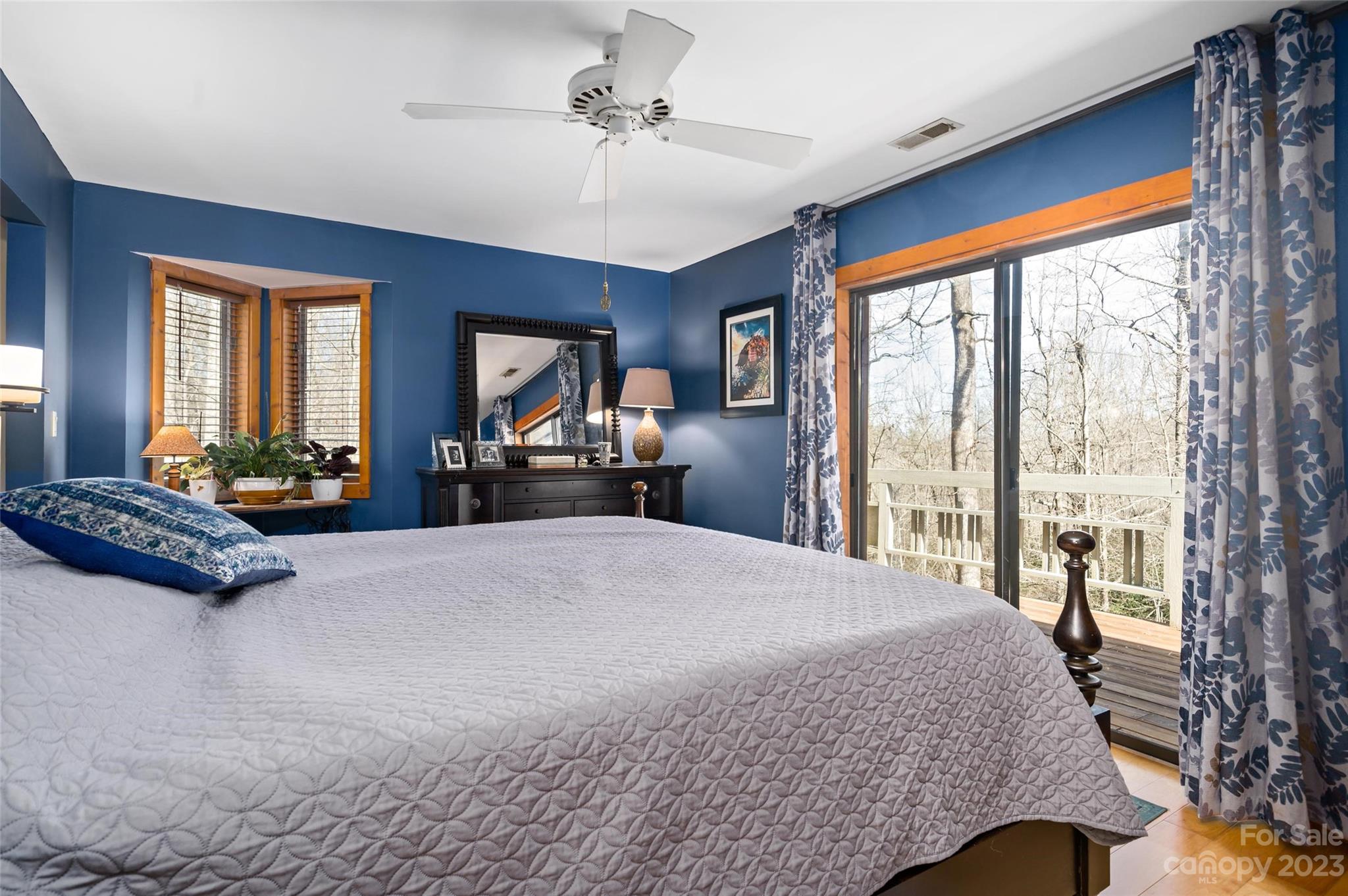 139 Panther Gap Road Brevard, NC 28712 - Photo 21 of 42 a bedroom with a large bed and a large window