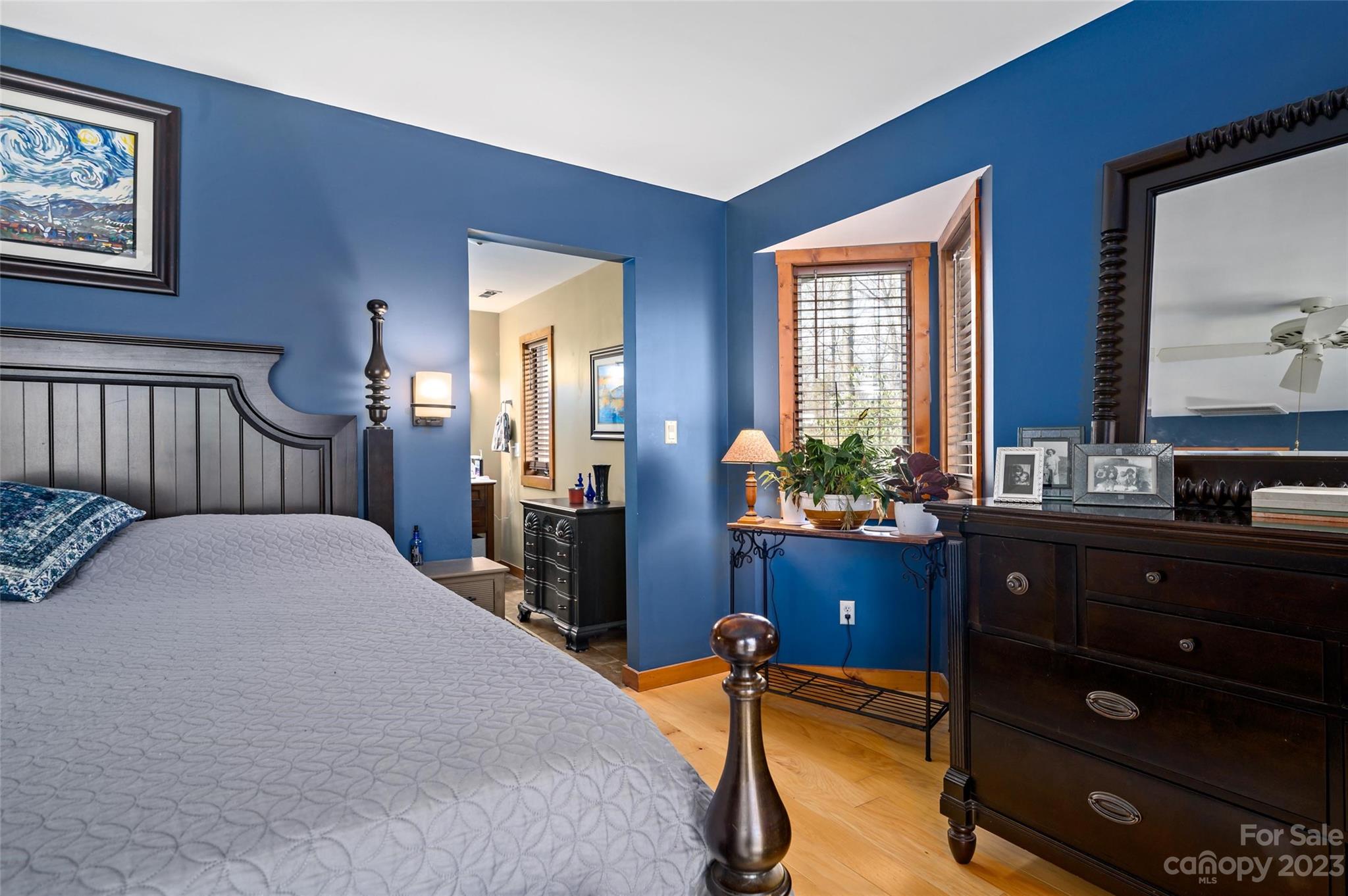 139 Panther Gap Road Brevard, NC 28712 - Photo 22 of 42 a bedroom with a bed and wooden floor