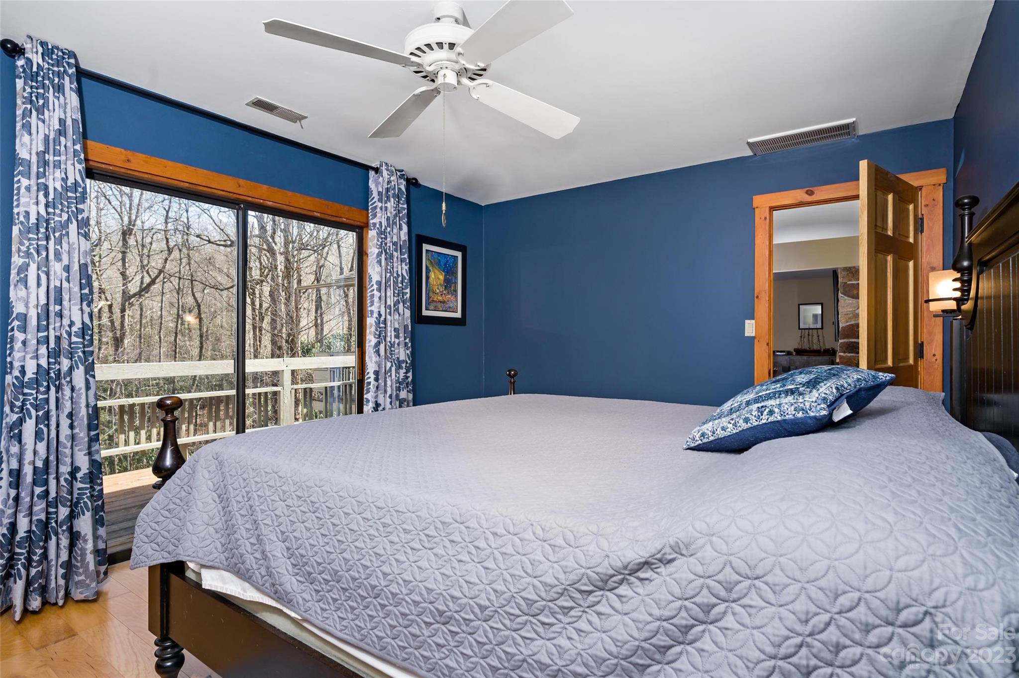 139 Panther Gap Road Brevard, NC 28712 - Photo 23 of 42 a bedroom with a large bed and a large window