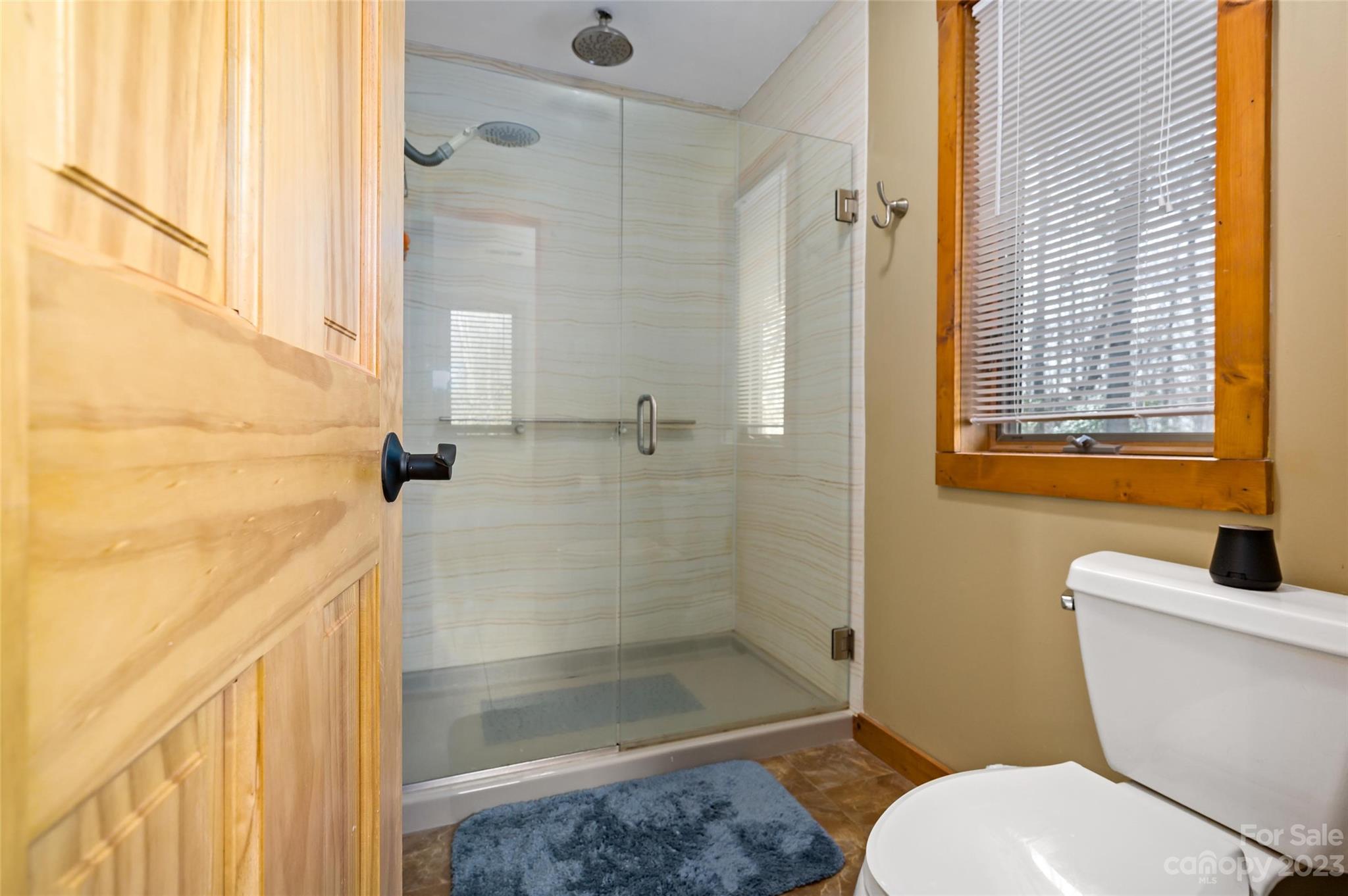 139 Panther Gap Road Brevard, NC 28712 - Photo 25 of 42 a white toilet sitting next to a bath tub shower