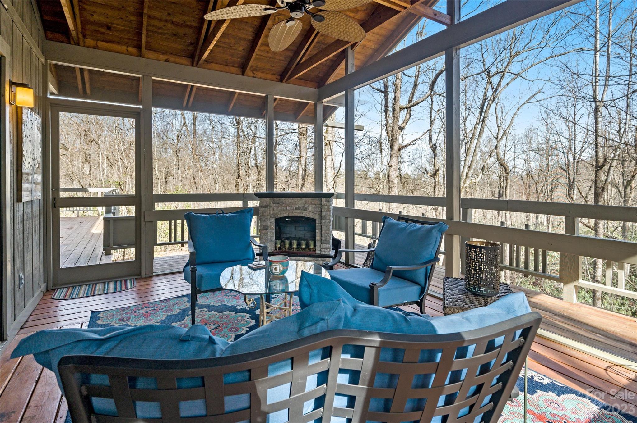 139 Panther Gap Road Brevard, NC 28712 - Photo 30 of 42 a living room with furniture a table and a fireplace