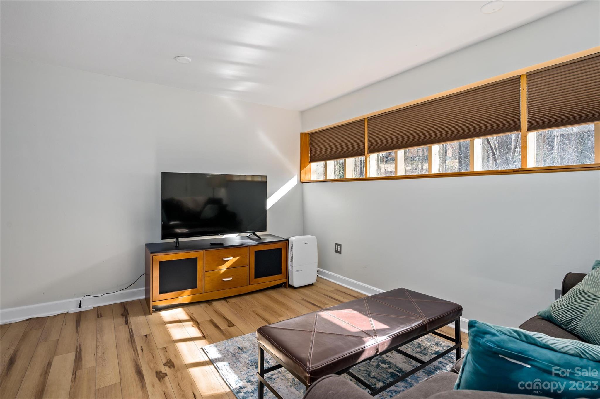 139 Panther Gap Road Brevard, NC 28712 - Photo 31 of 42 a living room with furniture and a flat screen tv
