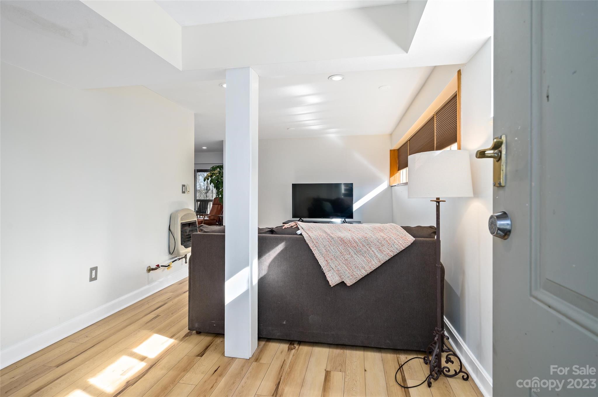 139 Panther Gap Road Brevard, NC 28712 - Photo 32 of 42 a living room with a bed furniture and a flat screen tv