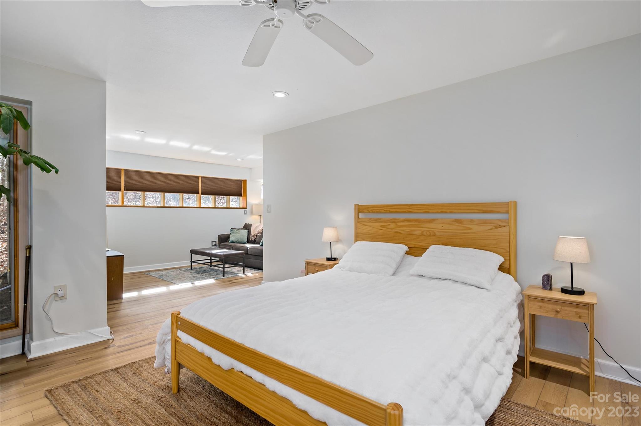 139 Panther Gap Road Brevard, NC 28712 - Photo 34 of 42 a bedroom with a bed and a chandelier