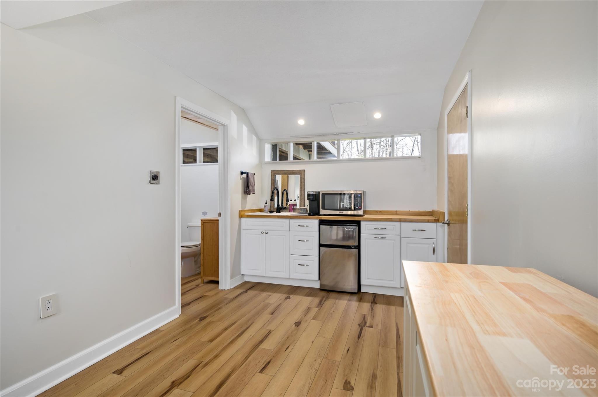 139 Panther Gap Road Brevard, NC 28712 - Photo 35 of 42 a kitchen with cabinets and wooden floor