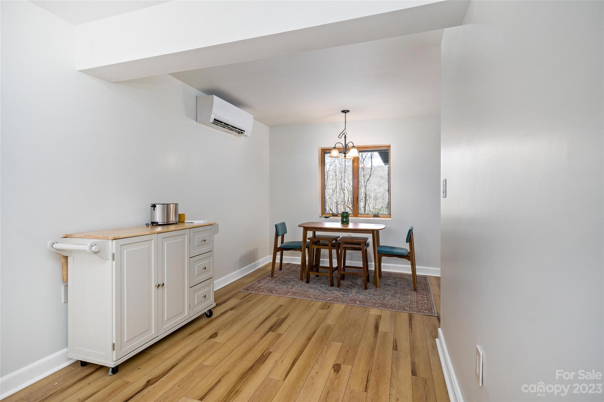 139 Panther Gap Road Brevard, NC 28712 - Photo 37 of 42 a view of a dining room with furniture window and wooden floor