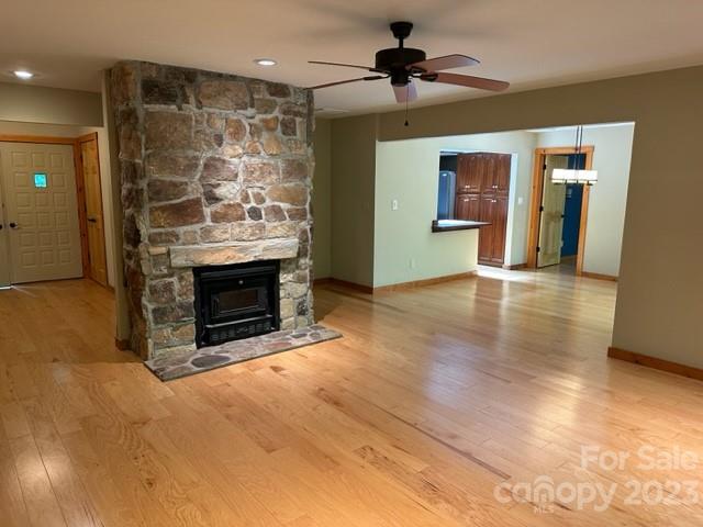 139 Panther Gap Road Brevard, NC 28712 - Photo 40 of 42 a view of a livingroom with a fireplace and a chandelier