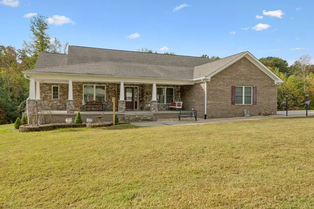 a view of a house with swimming pool and porch with furniture
