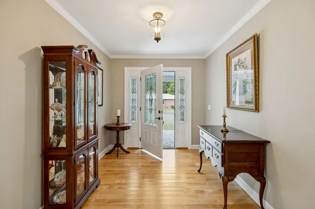 a large kitchen with stainless steel appliances granite countertop a large refrigerator a sink a stove top oven and cabinets