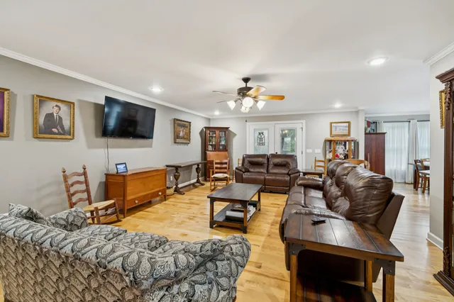 a kitchen with stainless steel appliances a dining table chairs and a refrigerator